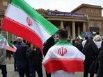 Iranian healthcare workers gather for a rally condemning attacks on health facilities by the US and Israel, outside Imam Khomeini Hospital in Tehran.