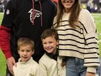 Kirk Cousins and Julie Cousins share a warm moment on the field,