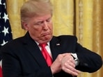 President Donald Trump checks his watch during an event to celebrate federal judicial confirmations in the East Room 