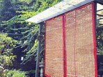 A vetiver curtain gently cooled with water releases a woody fragrance while soft summer breezes pass through the woven roots.