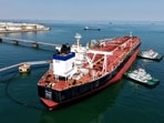 An oil tanker is docked unloading crude oil at the port in Qingdao, in China's eastern Shandong province