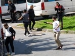 A man holds a gun, after gunfire was heard near the building housing the Israeli consulate, according to a witness, in Istanbul, Turkey, April 7