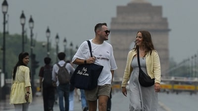 Gram it: What's rain without a reason to walk at the scenic Kartavya Path. Here are some pedestrians doing exactly that as Tuesday witnessed a fresh spell of rain amid yellow alert for thunderstorms and gusty winds in the NCR. (Photo: Naveen Sharma/ANI)