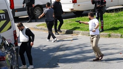 A man holds a gun, after gunfire was heard near the building housing the Israeli consulate, according to a witness, in Istanbul, Turkey, April 7 (REUTERS)