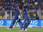 Rohit Sharma walks past Hardik Pandya after losing his wicket.