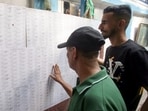 Locals look for their names in a list during the Special Intensive Revision of electoral rolls in Kolkata on Sunday. (ANI)