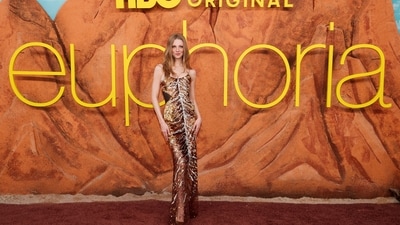 Hunter Schafer stunned in Roberto Cavalli Spring 2026 creation featuring a glamorous, figure-hugging gold sequin gown with a corset-style bodice and delicate straps. The styling was kept minimal to let the intricate embellishments of the dress shimmer in their own light. (REUTERS)