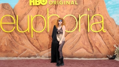 Natasha Lyonne made a bold, edgy statement in a sheer black bodysuit layered with a black overcoat draped along one shoulder. The outfit was paired with lace-patterned tights, nude corseted shorts, chunky boots, bold jewellery and statement sunglasses. (Getty Images via AFP) Natasha Lyonne made a bold, edgy statement in a sheer black bodysuit layered with a black overcoat draped along one shoulder. The outfit was paired with lace-patterned tights, nude corseted shorts, chunky boots, bold jewellery and statement sunglasses. (Getty Images via AFP)