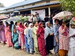 Kamrup [Assam], Apr 09 (ANI): Voters queue up as they wait to cast their votes amid rain at the polling station during the Assam Assembly Elections 2026 in Kamrup on Thursday. (ANI Photo)