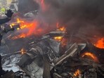 A rescue worker extinguishes burning cars at the site of an Israeli airstrike in central Beirut, Lebanon.