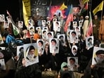 Shiite Muslims hold portraits of Iran's supreme leaders, Ali Hosseini Khamenei and his son Mojtaba Khamenei as they celebrate after the United States and Iran agreed to a two-week ceasefire on April 8, 2026. Pakistan's Prime Minister Shehbaz Sharif said on April 8, 2026, that Islamabad would host delegations from the United States and Iran later this week following their ceasefire announcement. (Photo by Asif HASSAN / AFP)