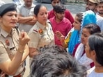 Police personnel seen with protesting workers on Thursday. (Parveen Kumar/HT)