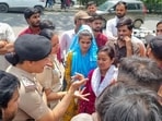 Workers seen along with police personnel during the protest on Thursday. (Parveen Kumar/HT)