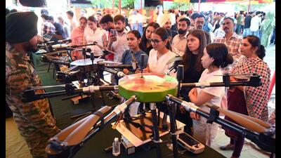 Students gather around a stall, examining military equipment and interacting with personnel on Day 1 of the annual literary and cultural festival ‘Kavach 3.0’ at Panjab University. (Keshav Singh/HT)