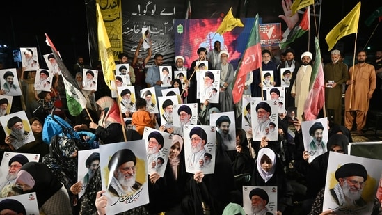 Shiite Muslims hold portraits of Iran's supreme leaders, Ali Hosseini Khamenei and his son Mojtaba Khamenei as they celebrate after the United States and Iran agreed to a two-week ceasefire on April 8, 2026. Pakistan's Prime Minister Shehbaz Sharif said on April 8, 2026, that Islamabad would host delegations from the United States and Iran later this week following their ceasefire announcement. (Photo by Asif HASSAN / AFP) (AFP)