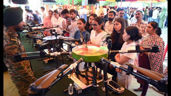 Students gather around a stall, examining military equipment and interacting with personnel on Day 1 of the annual literary and cultural festival ‘Kavach 3.0’ at Panjab University. (Keshav Singh/HT)