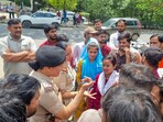 Workers of Richa Global Company argue with women police officers during a protest in IMT Manesar Sector 7 near Kasan Village, in Gurugram, India, on Thursday, 09 April 2026.(ParveenKumar/HT Photos)