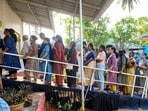 People wait in a queue to cast votes during the Kerala Assembly elections, at a polling station, in Thiruvananthapuram on Thursday. (PTI)