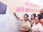 Delhi chief minister Rekha Gupta during a signature campaign at Delhi University’s Arts Faculty on Friday.