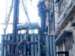 A PSPCL employee repairs a transformer in Ludhiana on Saturday. (HT Photo) A PSPCL employee repairs a transformer in Ludhiana on Saturday. (HT Photo)