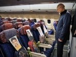 Iranian speaker Mohammad Bagher Ghalibaf carries the photos of school kids killed in an alleged US strike on a school in Minab. (X/@mb_ghalibaf)