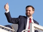 Vice President JD Vance gives a thumb up sign as he boards Air Force Two.
