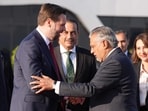 US Vice President JD Vance (C) shakes hands with Pakistani Deputy Prime Minister and Foreign Minister Mohammad Ishaq Dar (3rd R), as Pakistan's Chief of Defence Forces Chief of Army Staff Field Marshall Asim Munir (centre R) look on.