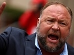 FILE PHOTO: Infowars founder Alex Jones speaks to the media after appearing at his Sandy Hook defamation trial at Connecticut Superior Court in Waterbury, Connecticut, U.S., October 4, 2022. REUTERS/Mike Segar/File Photo
