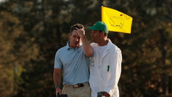 Golf - The Masters - Augusta National Golf Club, Augusta, Georgia, U.S. - April 12, 2026 Northern Ireland's Rory McIlroy celebrates with his caddie Harry Diamond on the green on the 18th hole after winning The Masters.