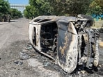 Wreckage of a car is seen after it was burnt during a protest by factory workers demanding a hike in wages, in Noida.