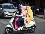 Pune, India -March 19, 2024:People wear scarf, gloves, goggles,during summer seasos at Laxmi road in Pune, India,Tuesday, -March 19, 2024-HT photo Pune, India -March 19, 2024:People wear scarf, gloves, goggles,during summer seasos at Laxmi road in Pune, India,Tuesday, -March 19, 2024-HT photo