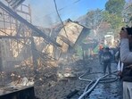 Firefighters took about five hours to douse the fire that broke out at the Heritage Market in Kasauli at 4am on Monday. (HT Photo)