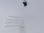 An Israeli helicopter releases flares, near the Israel-Lebanon border, as seen from the Israeli side of the border in northern Israel, April 14, 2026. 