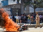 Flames billow as a police bike is set ablaze by factory workers during a protest demanding a hike in wages, in Noida, Gautam Buddh Nagar district, Uttar Pradesh.