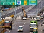 Vehicles pass by a closed section of the Delhi-Dehradun Expressway, in New Delhi. Vehicles pass by a closed section of the Delhi-Dehradun Expressway, in New Delhi.