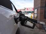 A motorist fills up the tank of a vehicle at a QuikTrip gasoline station Sunday, April 12, 2026 in Greenwood Village, Colo.