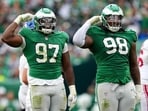 Moro Ojomo #97 and Jalen Carter #98 of the Philadelphia Eagles celebrate after a sack against the New York Giants