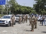 Personnel deployed as police commissioner of Gautam Buddh Nagar Lakshmi Singh visits Sector 80 amid ongoing workers’ protest, in Noida on Tuesday. (PTI)