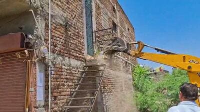 Local civic authorities in Amaravati moved in with earthmovers and razed an illegal portion of the accused’s home in Paratwada on Wednesday. (ANI Video Grab) Local civic authorities in Amaravati moved in with earthmovers and razed an illegal portion of the accused’s home in Paratwada on Wednesday. (ANI Video Grab)