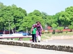 A mother gently shielding her son from the harsh sunlight at Sukhna Lake in Chandigarh on Wednesday. (Ravi Kumar/HT)