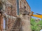 Local civic authorities in Amaravati moved in with earthmovers and razed an illegal portion of the accused’s home in Paratwada on Wednesday. (ANI Video Grab)
