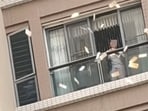 A woman was filmed throwing cash out of the window of a high-rise in China