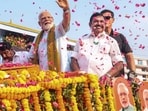 PM Narendra Modi and AIADMK chief Edappadi K Palaniswami greet people during a roadshow in Nagercoil on Wednesday. (PTI)