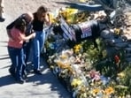 This image made from video provided by FOX News Digital shows Savannah Guthrie, right, her sister Annie Guthrie, left, and her brother-in-law Tommaso Cioni, Monday, March 2, 2026, visiting a tribute to their mother Nancy Guthrie. (FOX News Digital via AP)