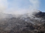 Smoke seen coming out from the Bandhwari Landfill as seen on Thursday. (Parveen Kumar/HT)