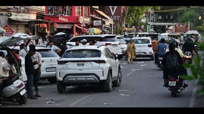 Vehicles parked on roadside outside commercial buildings in Civil Lines area. (Anil Kumar Maurya/HT)