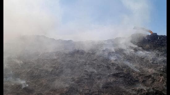 Smoke seen coming out from the Bandhwari Landfill as seen on Thursday. (Parveen Kumar/HT)