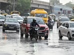 Commuters amid rain at Rajiv Chowk near Mini Secretariat, in Gurugram on Friday. (Parveen Kumar/HT Photo)