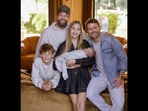 Country hitmaker Shane McAnally faces online backlash after a clip with his newborn baby sparks debate over surrogacy and parenting.