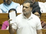 Rahul Gandhi holding up a sheet of paper with the number 16 on it, in the Lok Sabha on Friday.